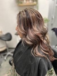 a woman's hair in a salon with long wavy hair